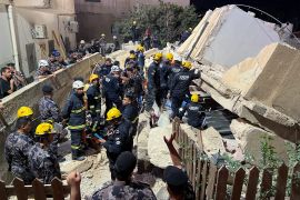 Civil defence members work at the site of a four-storey residential building collapse in Amman, Jordan September 13, 2022.