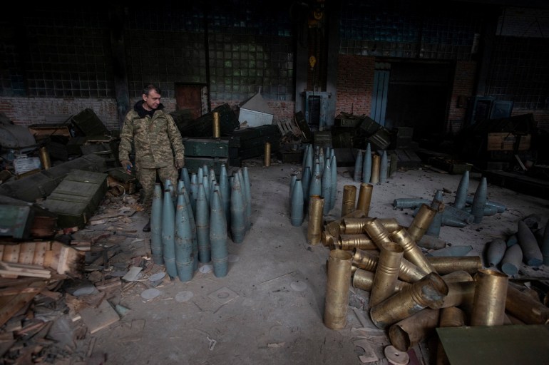 A Ukrainian service member checks Russia artillery shells captured during a counteroffensive operation, amid Russia's attack on Ukraine, near the town of Izium in Kharkiv region, Ukraine September 14, 2022. 