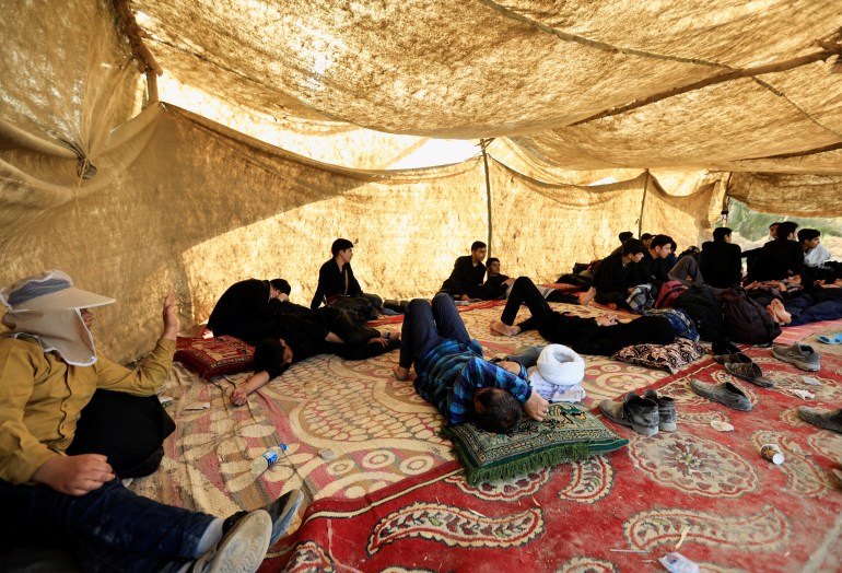 Shi'ite Muslim pilgrims rest during walk to the holy city of Kerbala,