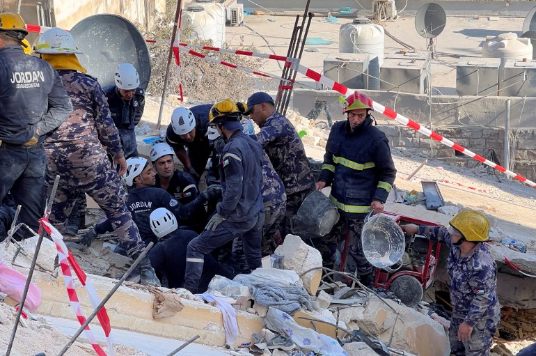 Rescuers work at the site of a collapsed building in Amman, Jordan September 15, 2022. 