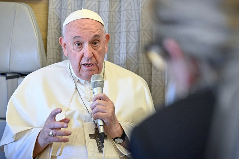 Pope Francis answers reporters' questions during a conference aboard the papal plane on his flight back to Rome after visiting Nur-Sultan, Kazakhstan
