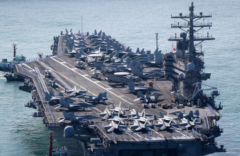 Fighter jets and helicopters on the flight deck of the USS Ronald Reagan as it nears the South Korean port of Busan