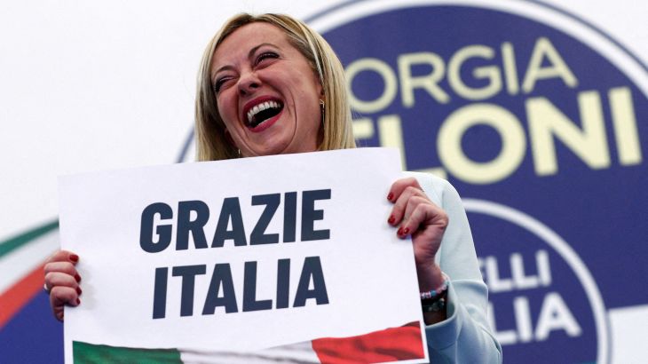 FILE PHOTO: Leader of Brothers of Italy Giorgia Meloni holds a sign at the party's election night headquarters, in Rome, Italy September 26, 2022.