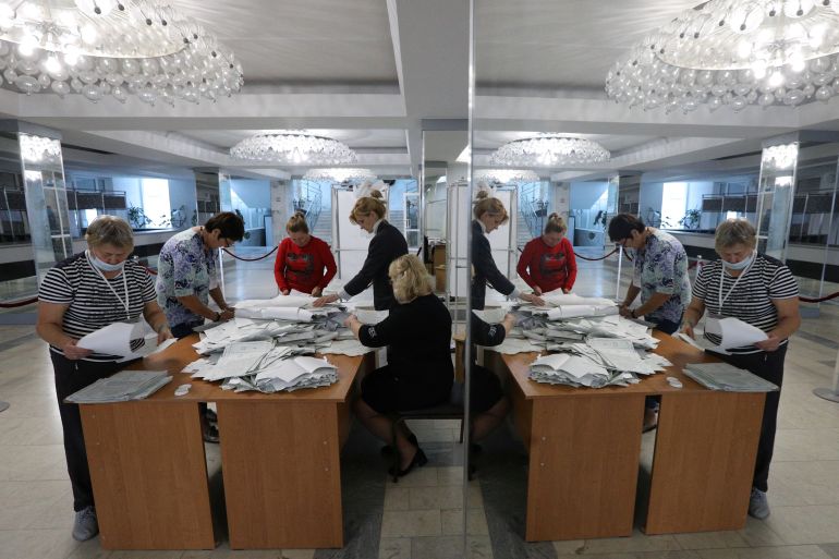 Women counting votes in Kremlin-backed referendums in Russian-occupied parts of Ukraine
