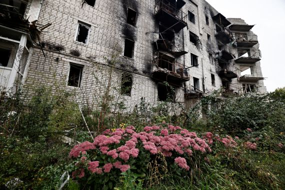 Flowers are pictured beside a destroyed building in the recently liberated town of Izium.