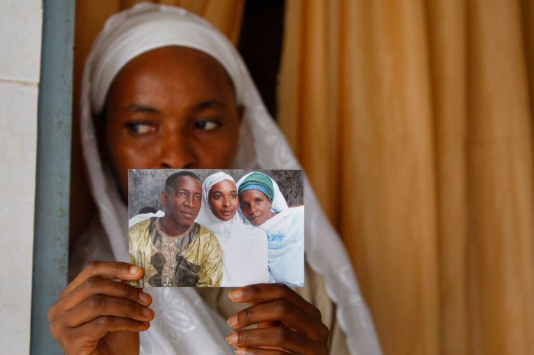 Widow Khadiatou Barry displays a wedding photograph showing her husband Alpha Oumar Diallo, who was killed on September 28, 2009 when security forces fired on pro-democracy demonstrators at a stadium in Guinea's capital Conakry [File: Rebecca Blackwell/AP]