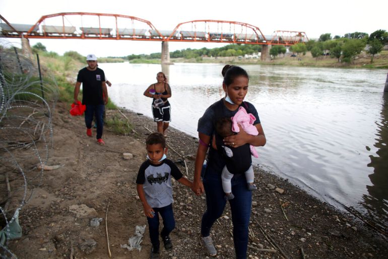 Migrants after crossing the Rio Grande river in Eagle Pass, Texas, in May 2022 [File: Dario Lopez-Mills/AP]