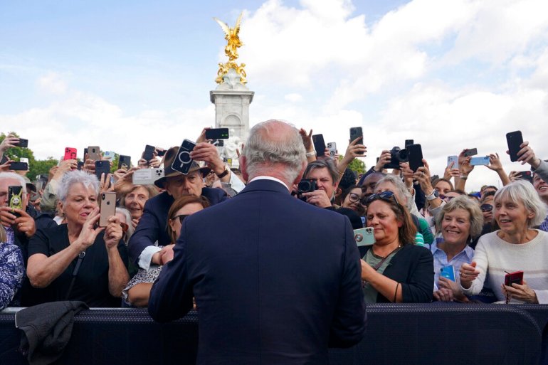 Britain's King Charles III, back to camera, greets well-wishers