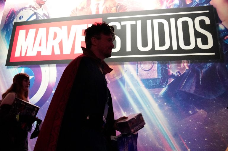 A cosplayer dressed as Doctor Strange passes by a Marvel Studios exhibit at the D23 Expo Saturday, Sept. 10, 2022, in Anaheim, Calif. (AP Photo/Mark J. Terrill)