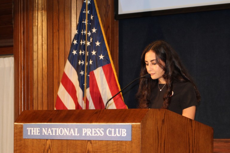 Lina Abu Akleh at a lectern of the National Press Club in Washington, DC.