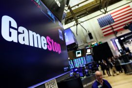 A screen displays the logo and trading information for GameStop on the floor of the New York Stock Exchange (NYSE) in New York City, U.S.
