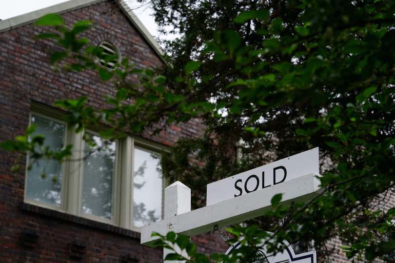 A "sold" sign is seen outside of a recently purchased home in Washington, U.S.
