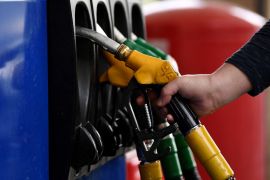 A man stops to refuel his car at a petrol filling station