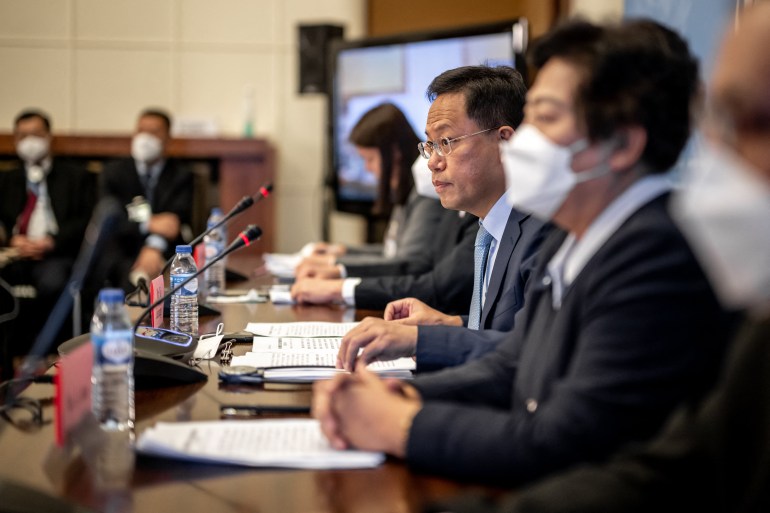 Chinese diplomats - all wearing face masks - hold a press conference after the UN rights chief released her long-delayed report on Xinjiang