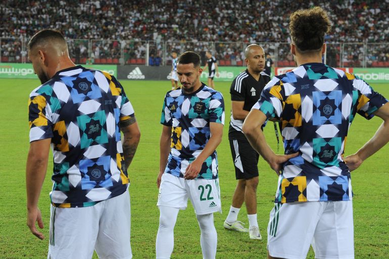 Algerian players are pictured during a friendly football match with Guinea on September 23, 2022 in Oran. - Morocco has asked German sportswear giant Adidas to cancel newly designed football tops for arch-rival Algeria, accusing it of appropriating "Moroccan cultural heritage", according to a lawyer's letter seen on September 29. Moroccan lawyer Mourad Elajouti, on behalf of the culture ministry, said a geometrical design pattern known as "zellige", common in Morocco's multi-coloured ceramic mosaics, appears on the Algerian top. (Photo by AFP)