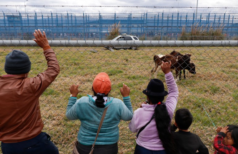Relatives stand outside a prison in Ecuador after a deadly riot