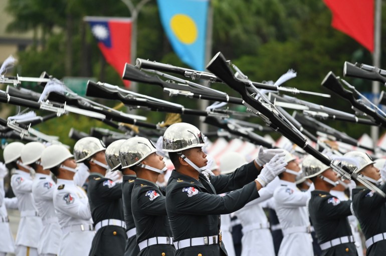 Honour guards parade with rifles during Taiwan's national day celebrations