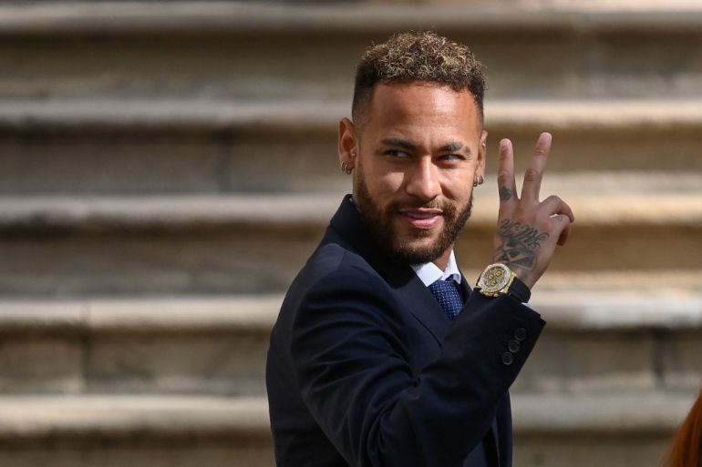Paris Saint-Germain's Brazilian forward Neymar gestures as he leaves after attending a hearing at the courthouse in Barcelona