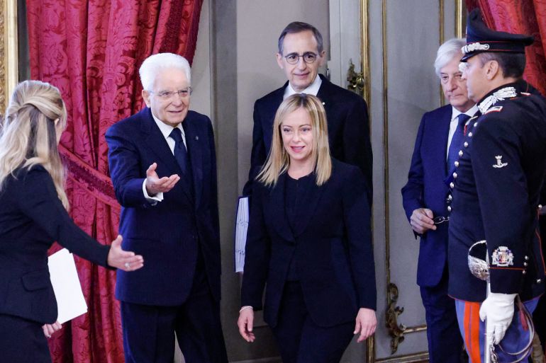 Italian President Sergio Mattarella (2nd L) welcomes new Prime Minister Giorgia Meloni (C) as she arrives for the swearing-in ceremony of the new Italian Government at the Quirinal Palace in Rome on October 22, 2022.