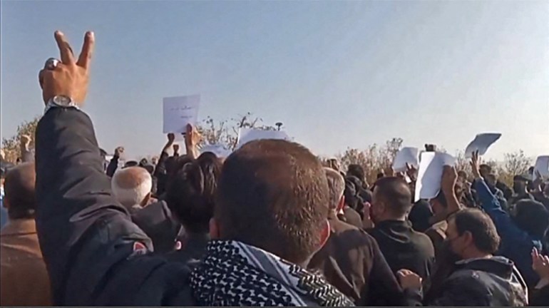 Iranian mourners marching towards Aichi cemetery in Saqez, Mahsa Amini's home town