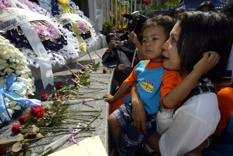 A Balinese mother and son mourn in front of the Bali Bombing Memorial during a commemorative service in Kuta, Bali, Indonesia in 2004
