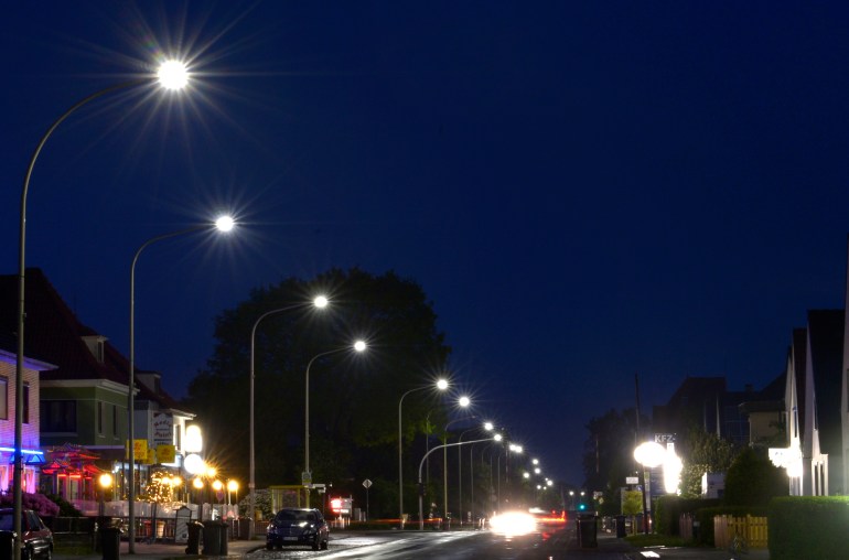 Light-emitting diode (LED) street lamps illuminate a road in Langen, Lower Saxony, May 23, 2013. Light-emitting diodes are taking over public spaces, saving thousands of euros in energy costs, although the price will deter households from making the switch for some time. LEDs are up to eight times more efficient than incandescent bulbs used in most homes but are still at least 10 times as expensive. The more expensive a lamp, the longer it needs to burn to write off the price, so it is more viable to use them in streets and hospitals than in homes where lights are off more than on. The town of Langen on Germany's North Sea coast has done the sums and two years ago became the first in Europe to replace its 2,583 street lights with LEDs at a cost of 1.7 million euros ($2.2 million). The town now spends about 79,000 euros a year to run its street lights - more than 60 percent less than before. Picture taken May 23. To go with story ENERGY-EFFICIENCY/LED REUTERS/Fabian Bimmer (GERMANY - Tags: BUSINESS SCIENCE TECHNOLOGY)