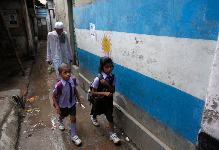 People pass by wall paint depicting the flag of 2014 World Cup participant Argentina, in Dhaka May 28, 2014. Millions of Bangladeshi football fans mostly support the national football teams of Argentina and Brazil. 