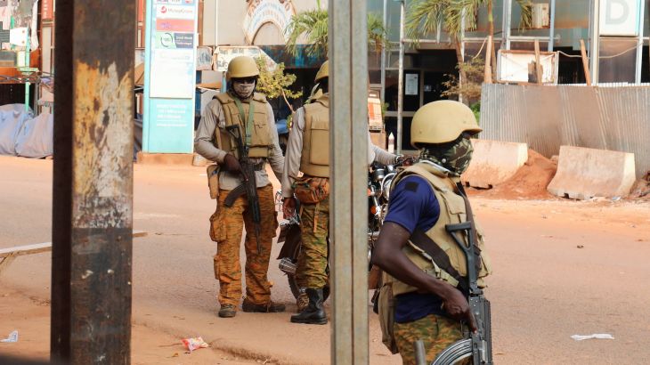 Soldiers stand guard on a street in Ouagadougou, Burkina Faso