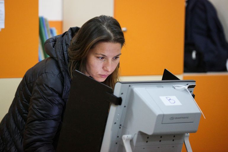 A woman votes at a polling station during a general election in Sofia.