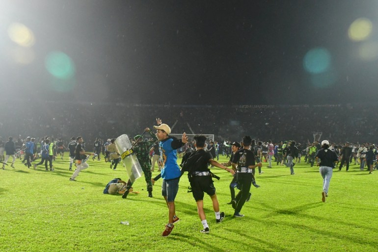 Supporters enter the field during the riot after the football match between Arema vs Persebaya at Kanjuruhan Stadium, Malang, East Java province, Indonesia, October 2, 2022.