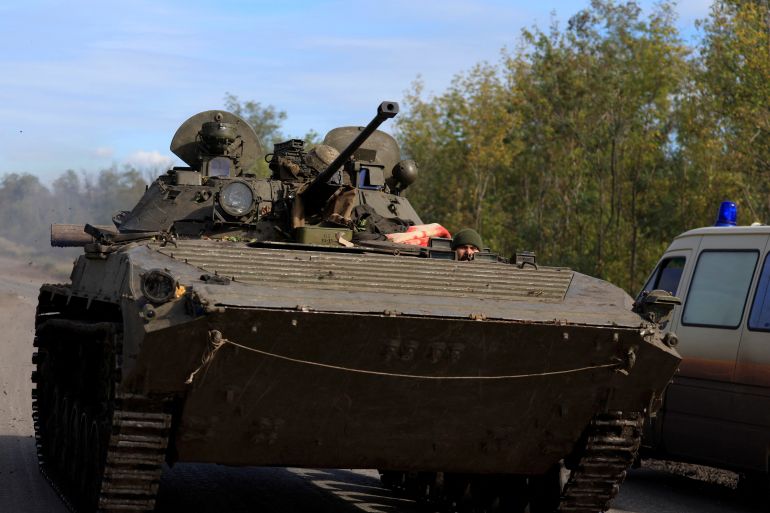 Ukrainian rides an armoured vehicle, amid Russia's attack on the country