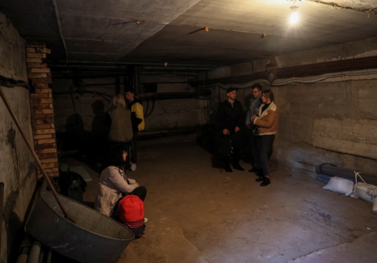 People shelter in a basement of a building 