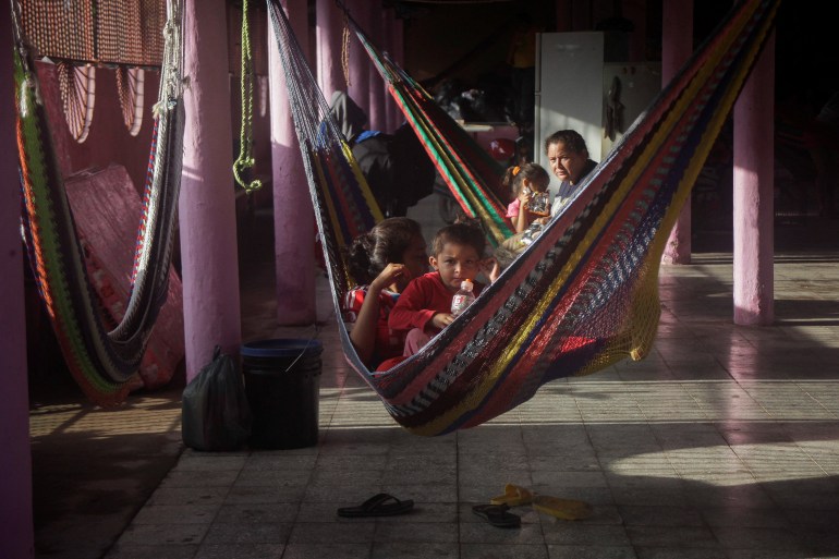 People rest in hammocks at a temporary shelter after storm Julia in Honduras.