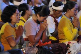 Men and women pray as they remember those who were killed in the Bali bombings 20 years ago