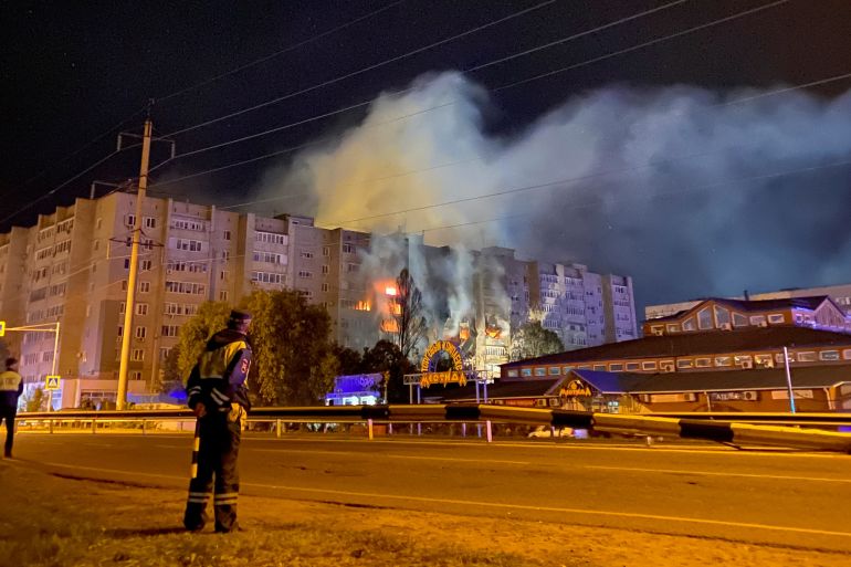 A view shows a site of a plane crash on residential building in the southern city of Yeysk, Russia