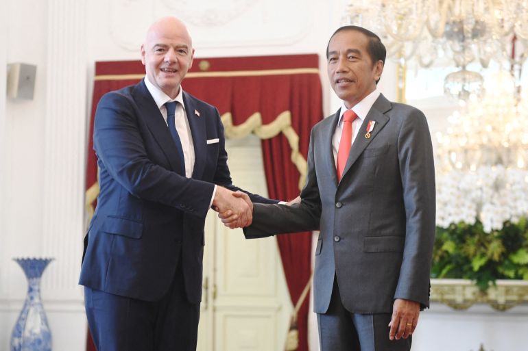 Indonesian President Joko Widodo shakes hands with FIFA?s president Gianni Infantino during their meeting at the Merdeka Palace in Jakarta, Indonesia