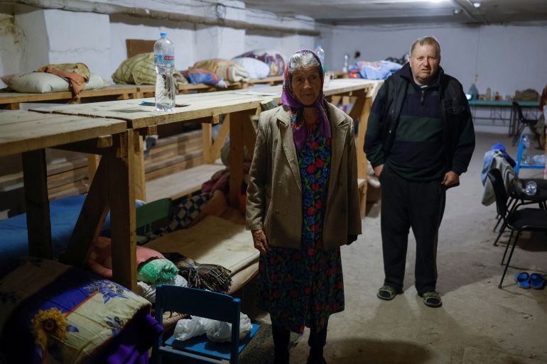Resident Yevdokiia Kolos, 82, stands in a bomb shelter, where she lives more than three months, amid Russia's attack on Ukraine, in the village of Lupareve near a front line in Mykolaiv region, Ukraine.