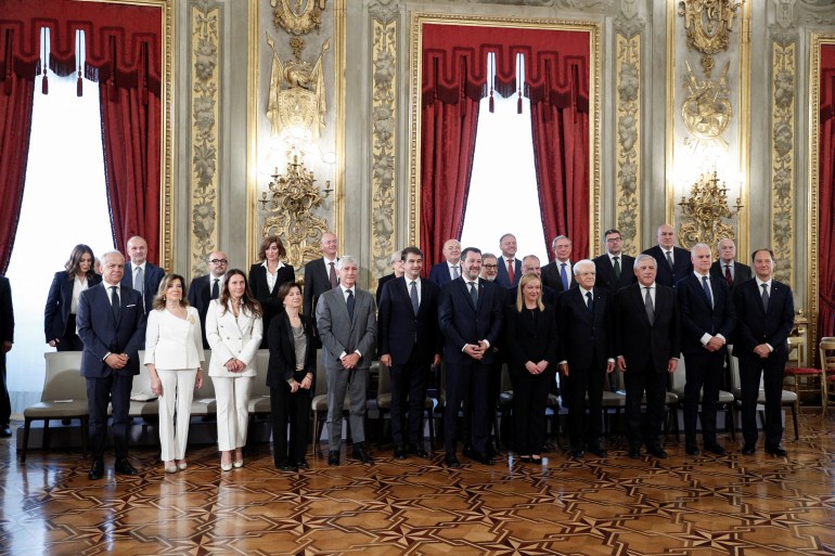Italian President Sergio Mattarella and Prime Minister Giorgia Meloni stand with the government's new cabinet ministers on the day of the swearing-in ceremony, at the Quirinale Presidential Palace in Rome, Italy