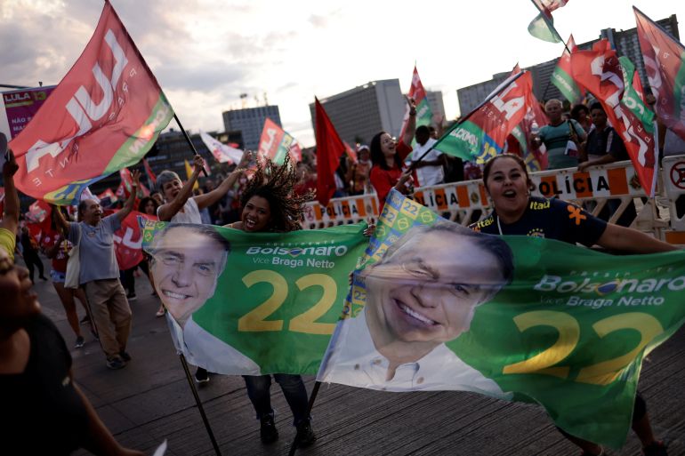 Supporters of Jair Bolsonaro and Lula da Silva wave flags in Brazil