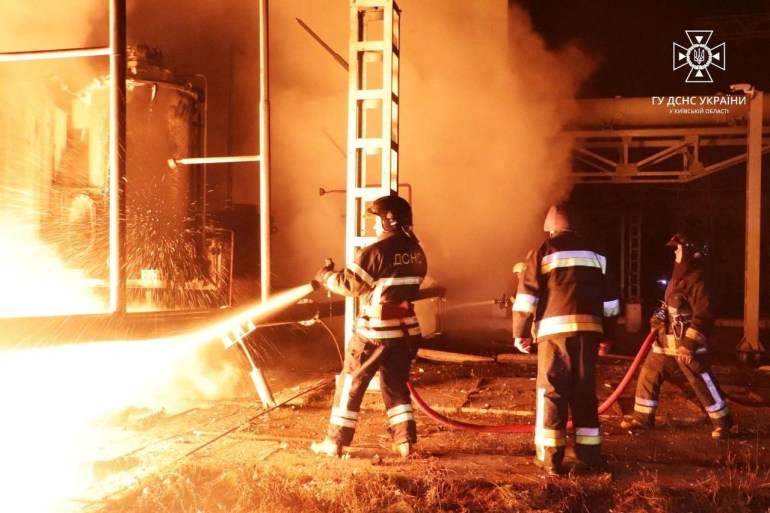 Firefighters work to put out a fire at energy infrastructure facilities, damaged by a Russian drone strike