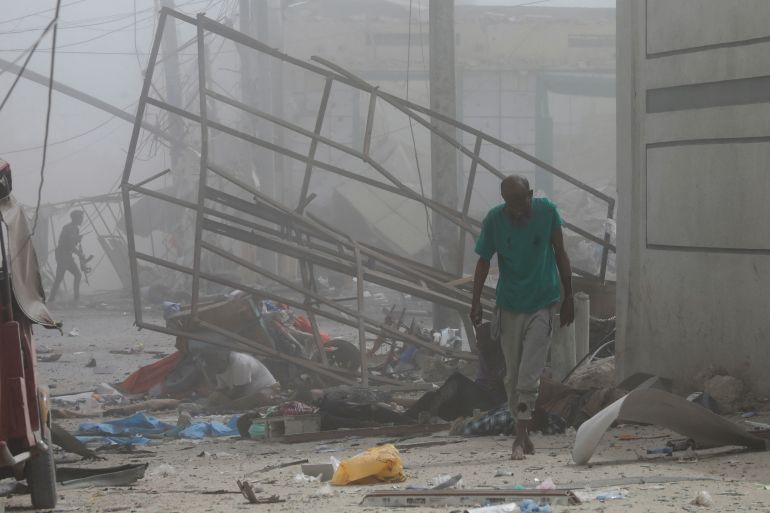 Wounded civilians are seen after explosions near the education ministry building in Mogadishu on Saturday