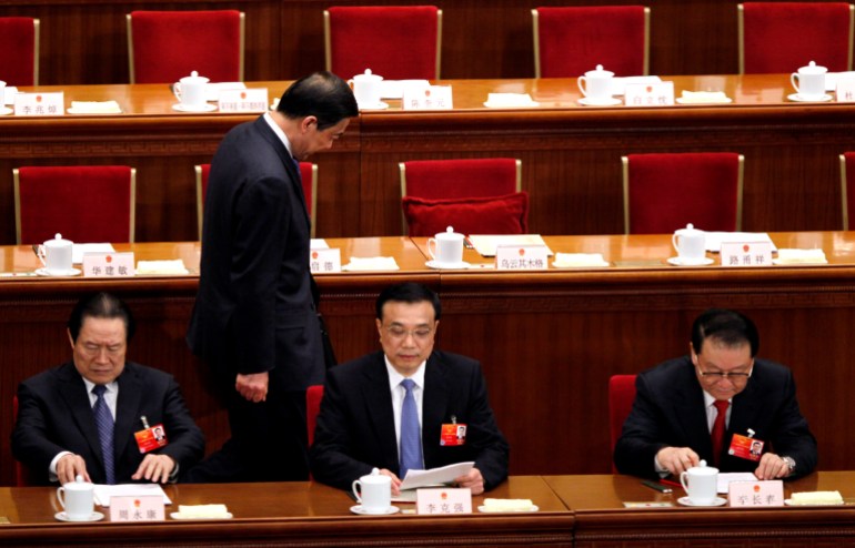 Chongqing party secretary Bo Xilai, walks past other Chinese leaders from left, Zhou Yong Kang, China's Communist Party head of Political and Legislative affairs committee, Vice Premier Li Keqiang and propaganda chief Li Changchun in the Great Hall of the People. Zhou was later found guilty of corruption too