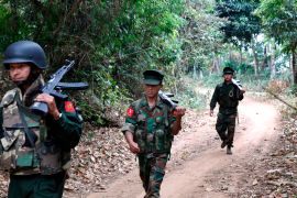 In this March 17, 2018 photo, Kachin Independence Army fighters walk in a jungle path in northern Kachin state, Myanmar.