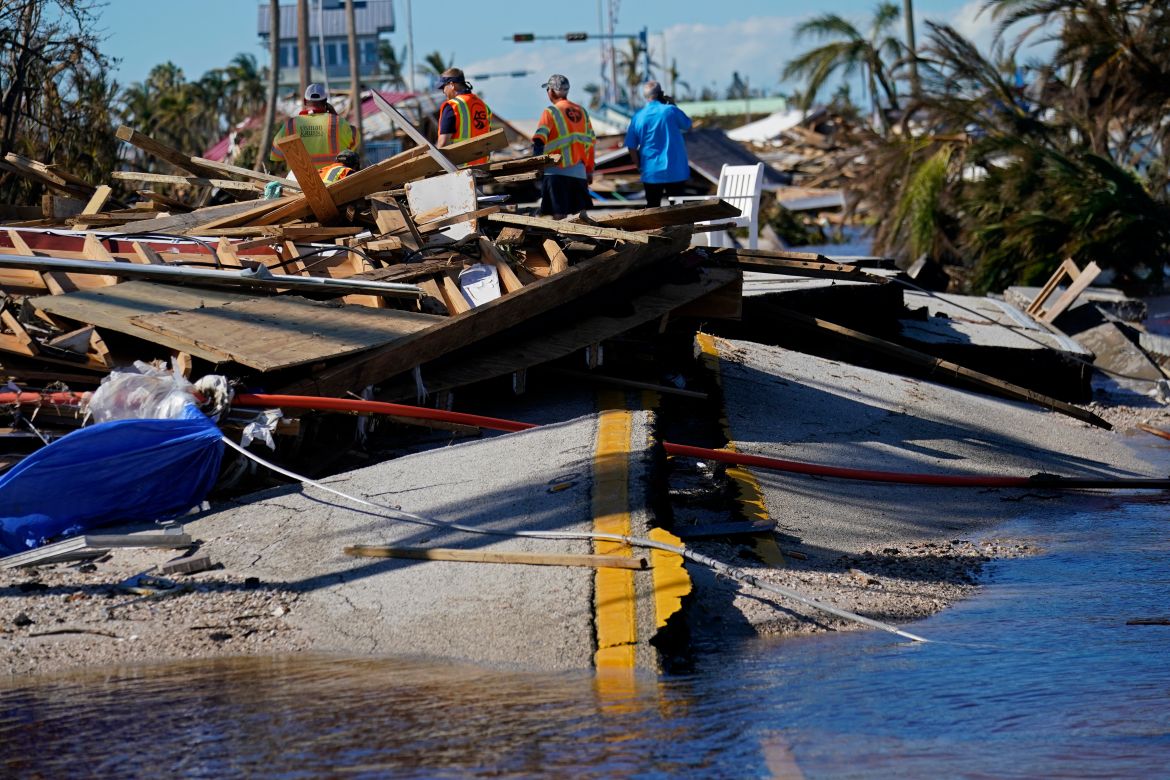 Responders from the de Moya Group survey damage to the bridge leading to Pine Island, to start building temporary access to the island in the aftermath of Hurricane Ian in Matlacha