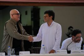 Representatives for the Colombian government and the ELN rebel group shake hands at peace talks in Venezuela.