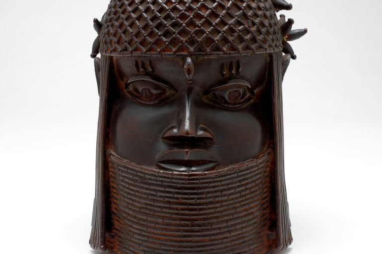 The "Head of a King", a dark, bronze sculpture, shows the king wearing a cap of coral beads with a single cowrie shell placed on the middle of his forehead