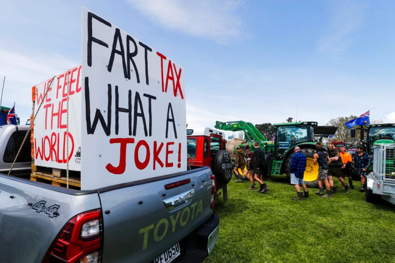 A sign on the back of a pickup truck reads 'FART TAX WHAT A JOKE!' as New Zealand farmers protest in central Auckland, New Zealand, on government plans to make them pay for greenhouse gas emissions.
