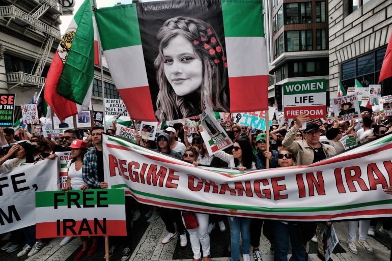 Demonstrators carry a large photo of Mahsa Amini during a protest against the Iranian regime, in Los Angeles.