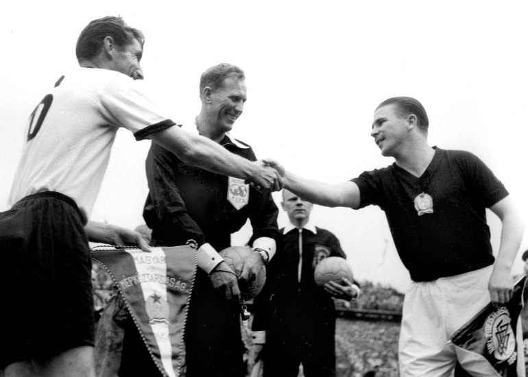 The two captains, Ferenc Puskas of Hungary, right, and Fritz Walter of West Germany shake hands