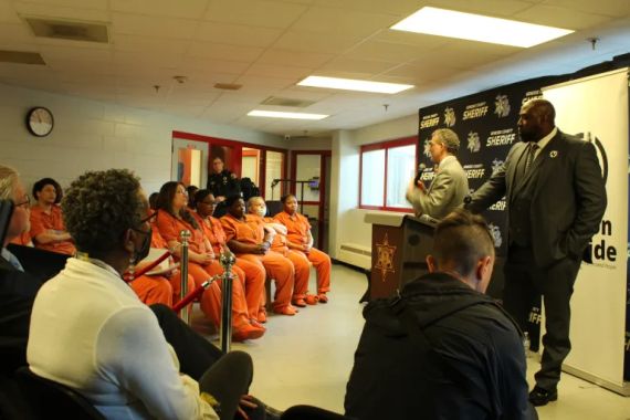 Incarcerated people listen to candidates speak about the election